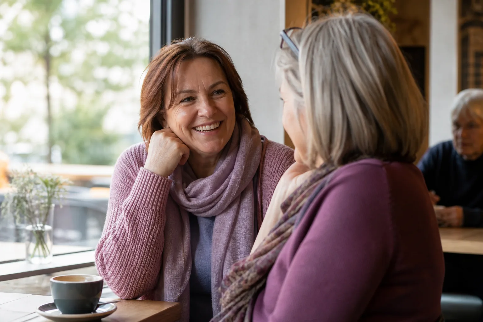 Mature woman enjoying a relaxed conversation over coffee in Cheshire